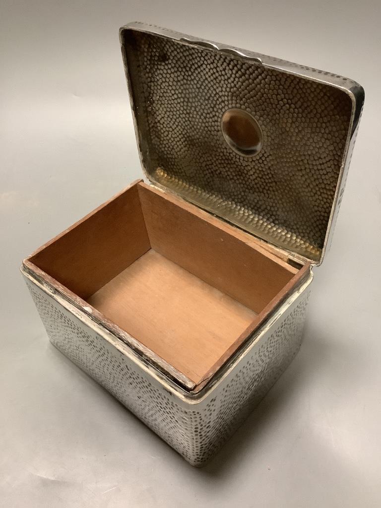 A late Victorian hammered silver cigarette box, London 1898, which 16 cm, gross weight, 32.5 ounces.